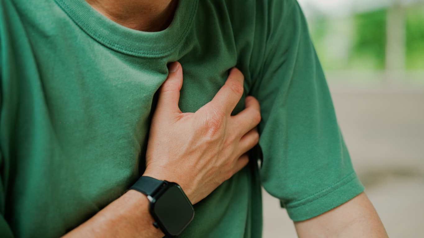 Man clutching chest after experiencing pain