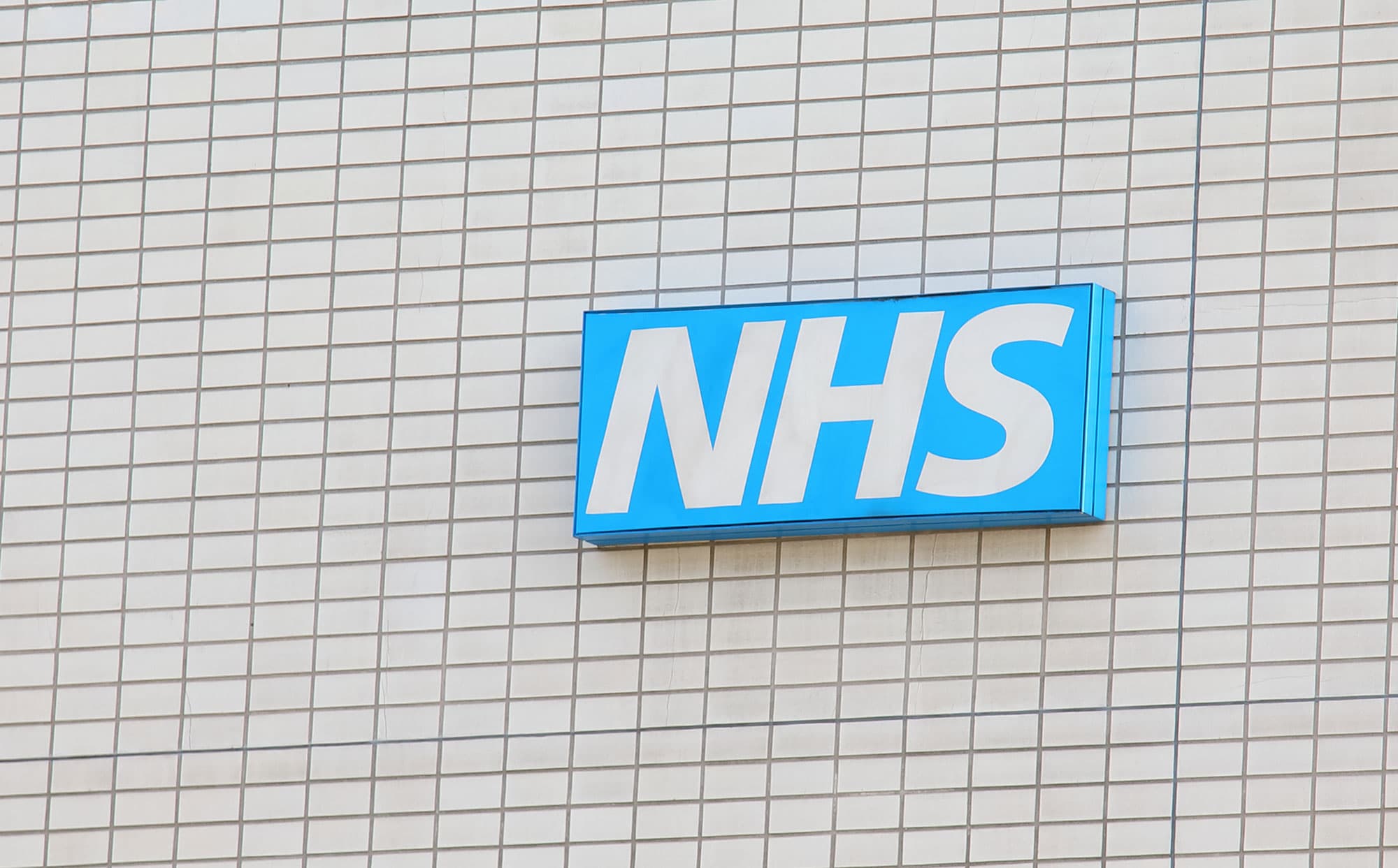 NHS sign on a wall