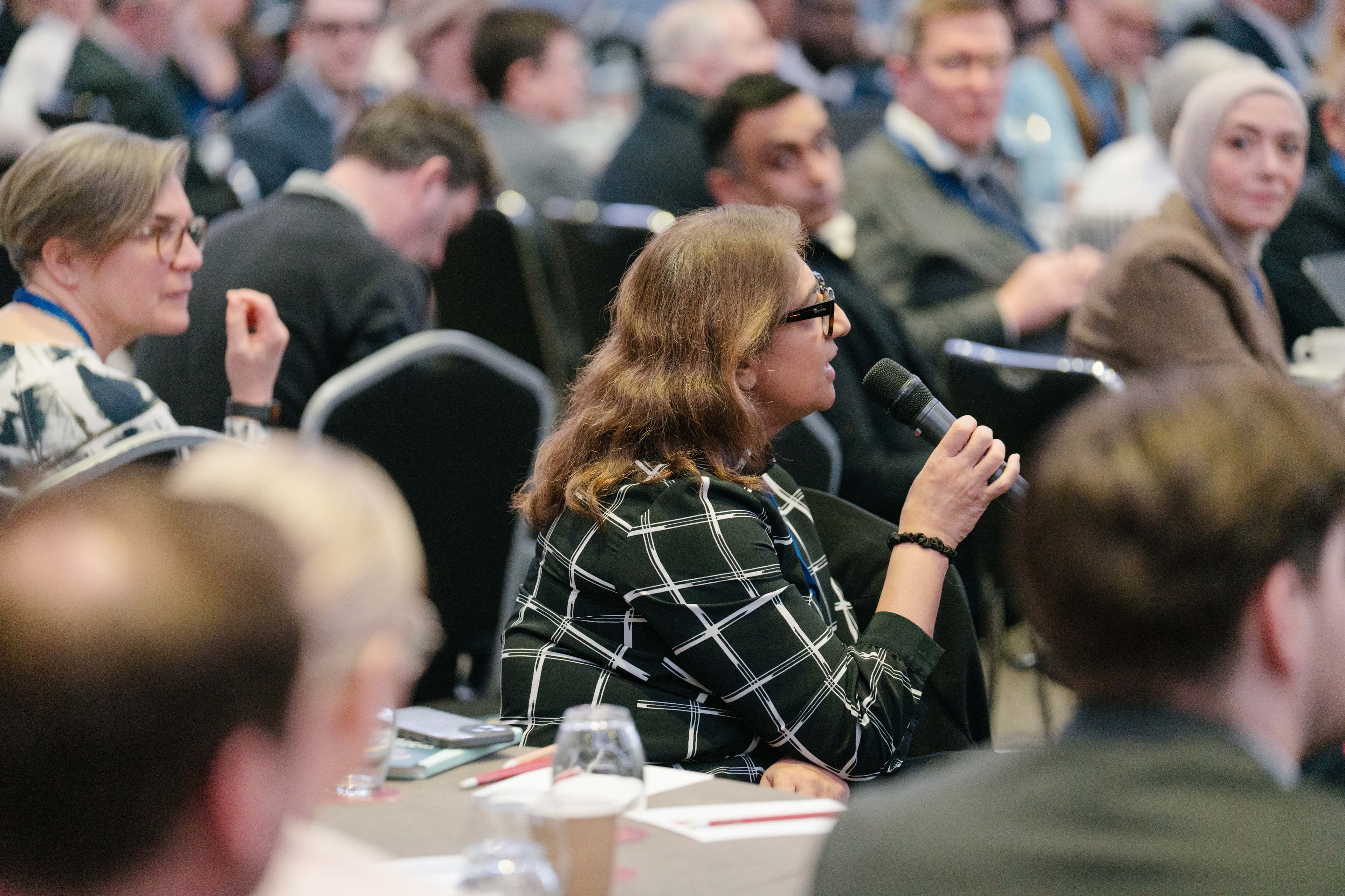 Delegate asking question in plenary session